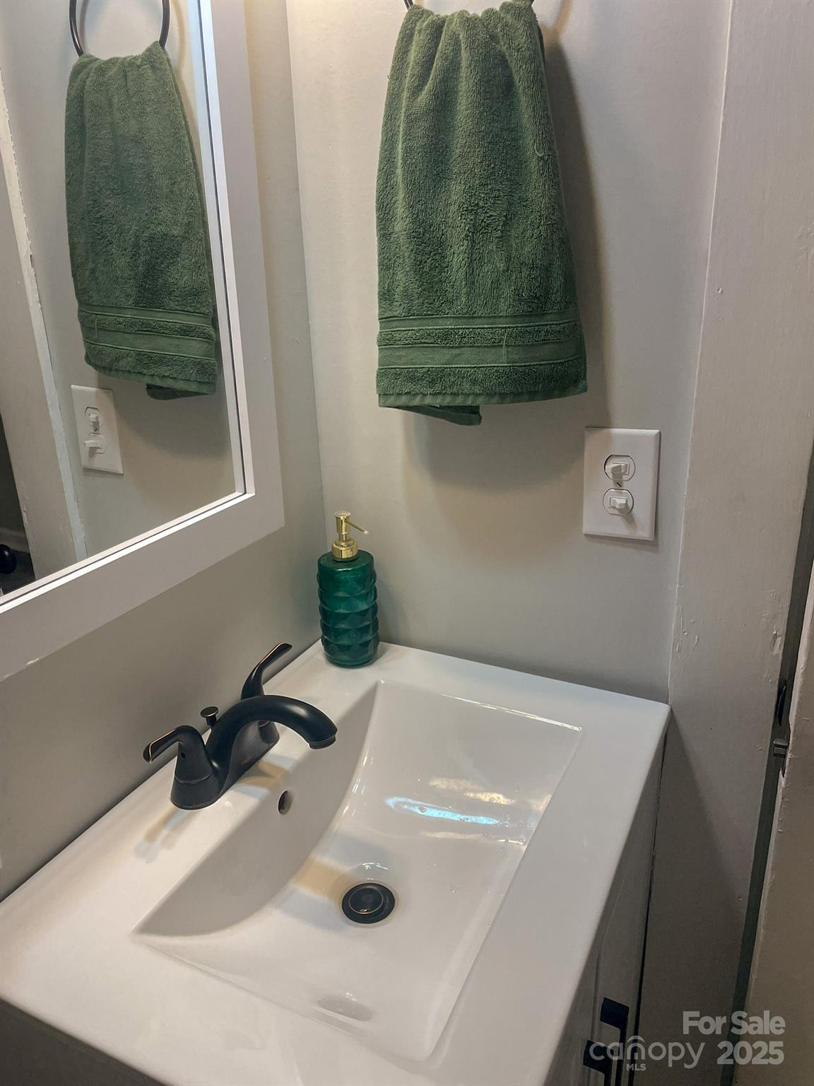 107 Byrd Street Morganton, NC 28655 - Photo 15 of 46 a bathroom with a sink and a mirror