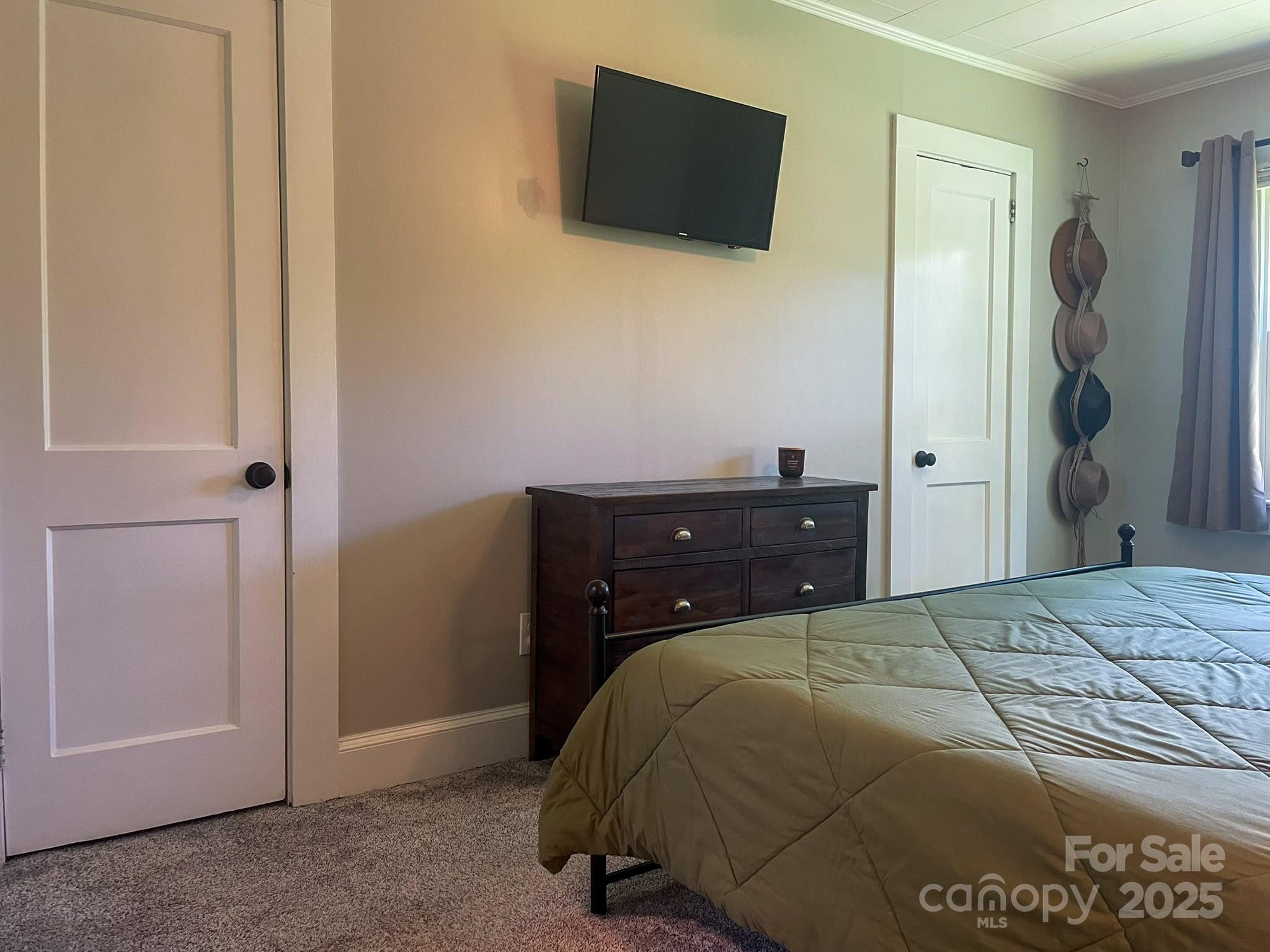 107 Byrd Street Morganton, NC 28655 - Photo 17 of 46 a bedroom with a bed and a flat tv screen on dresser