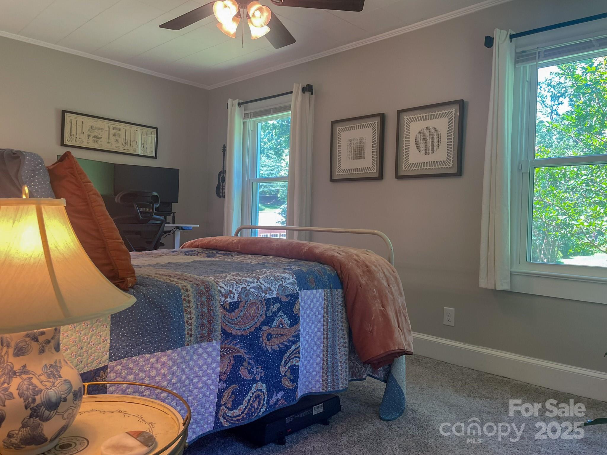 107 Byrd Street Morganton, NC 28655 - Photo 19 of 46 a bedroom with a bed and a lamp next to a window