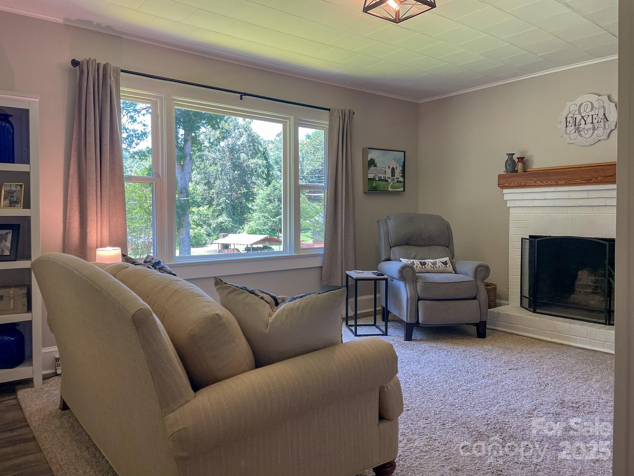 107 Byrd Street Morganton, NC 28655 - Photo 2 of 46 a living room with furniture and a fireplace