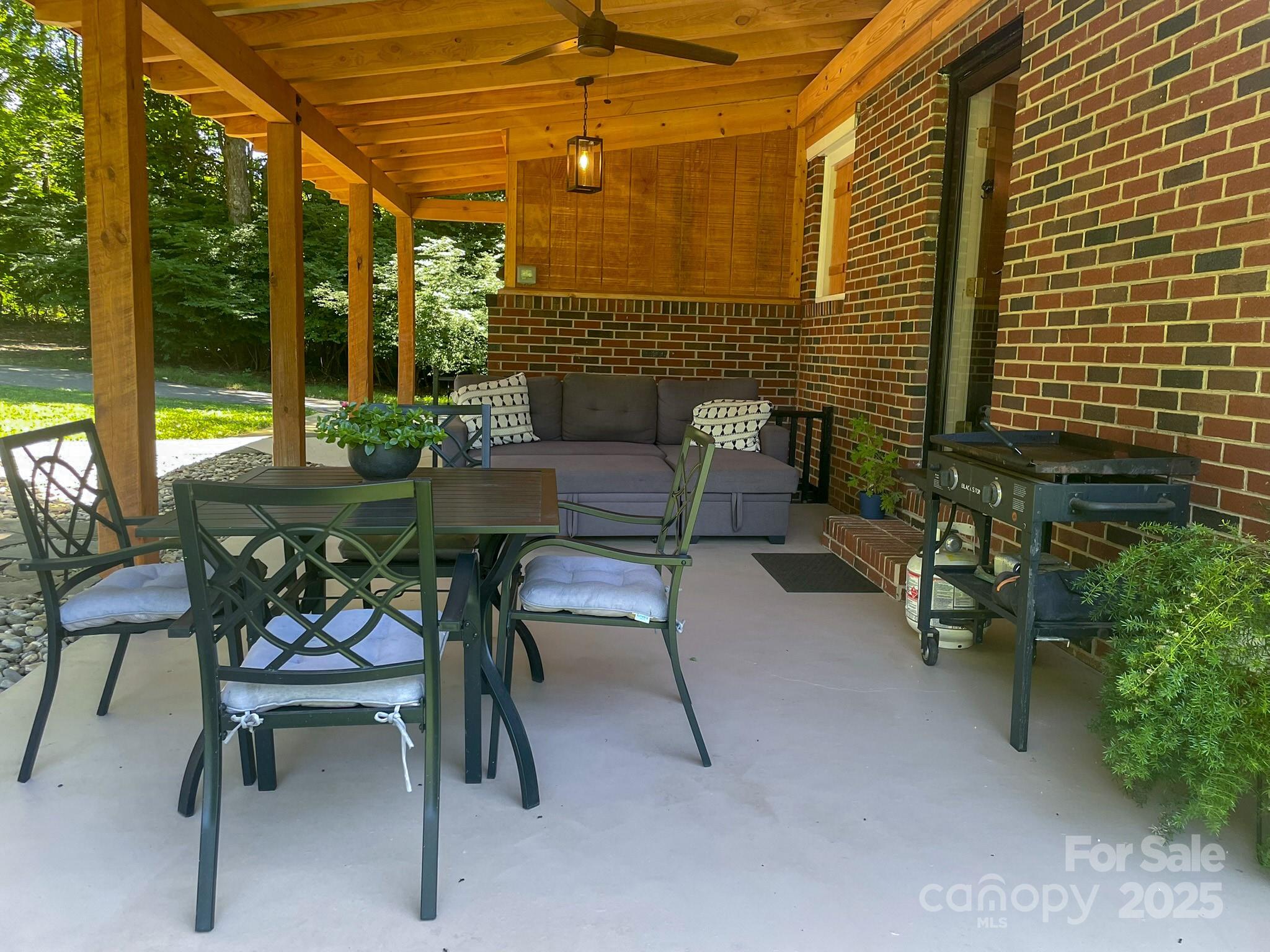 107 Byrd Street Morganton, NC 28655 - Photo 23 of 46 a view of a patio with a table and chairs and potted plants