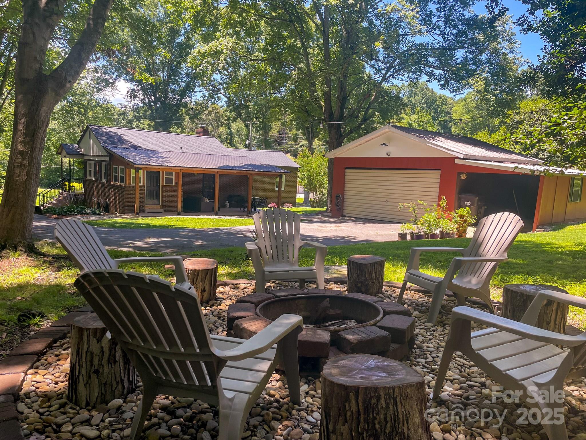 107 Byrd Street Morganton, NC 28655 - Photo 28 of 46 a view of a patio with table and chairs under an umbrella