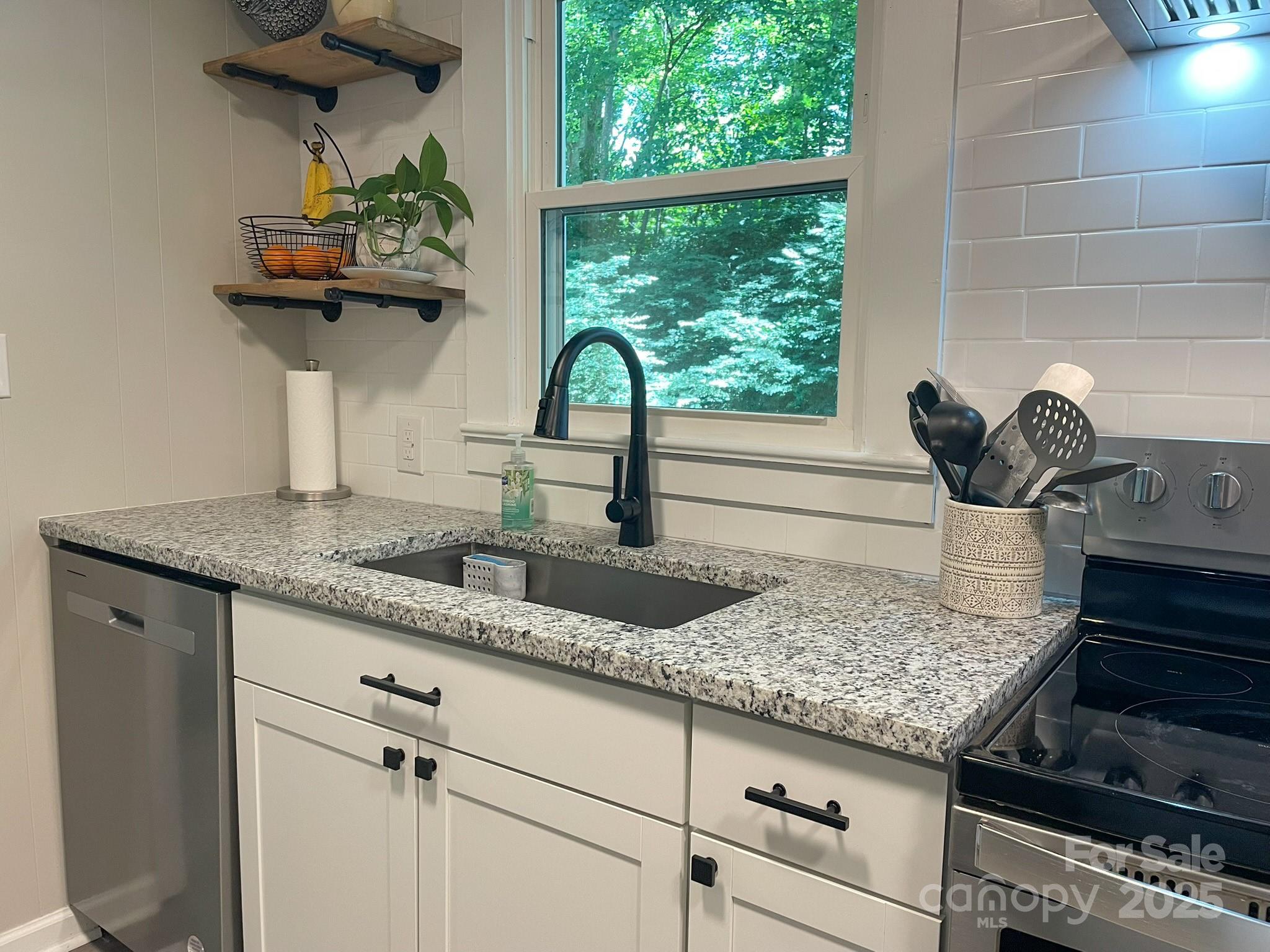 107 Byrd Street Morganton, NC 28655 - Photo 8 of 46 a kitchen with a stove a sink and a window