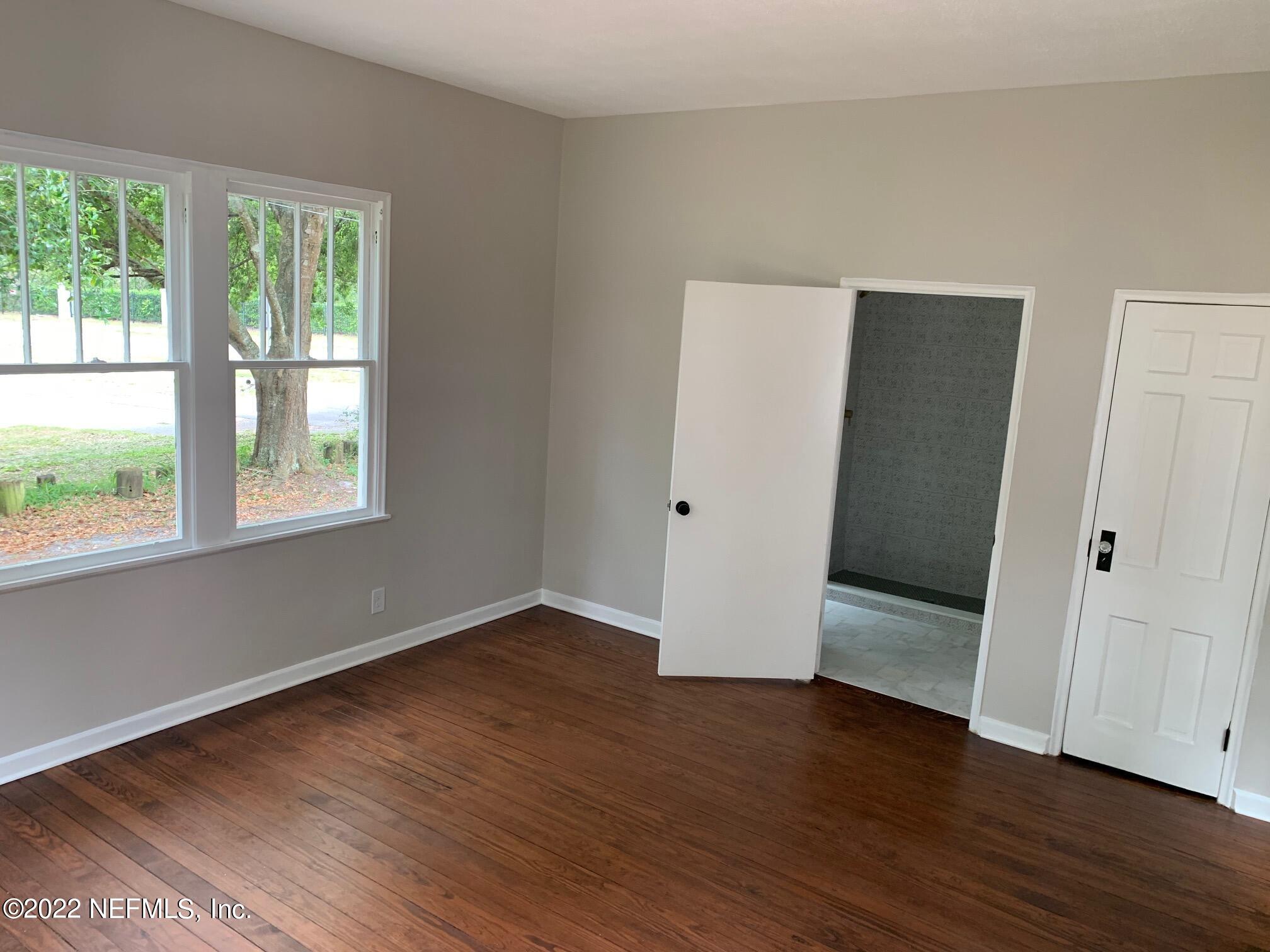 1821 Anniston Road Jacksonville, FL 32246 - Photo 2 of 11 a view of an empty room with wooden floor and a window