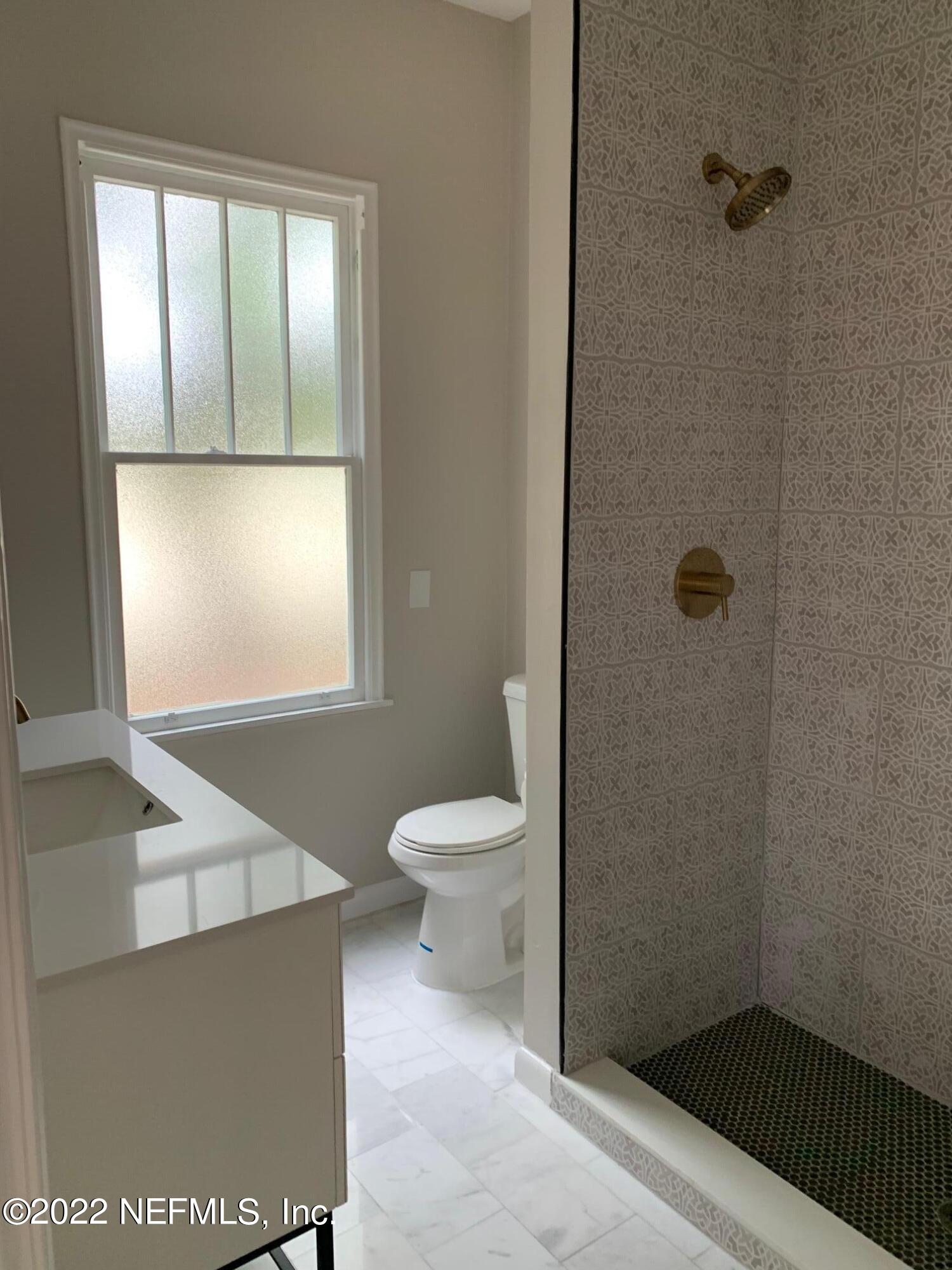1821 Anniston Road Jacksonville, FL 32246 - Photo 3 of 11 a bathroom with a toilet a sink and a window