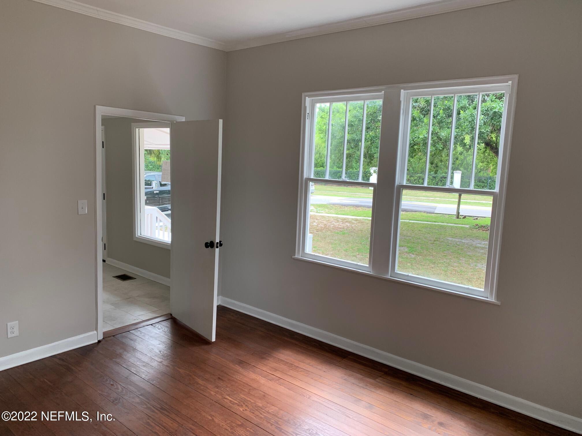 1821 Anniston Road Jacksonville, FL 32246 - Photo 6 of 11 a view of an empty room with wooden floor and a window