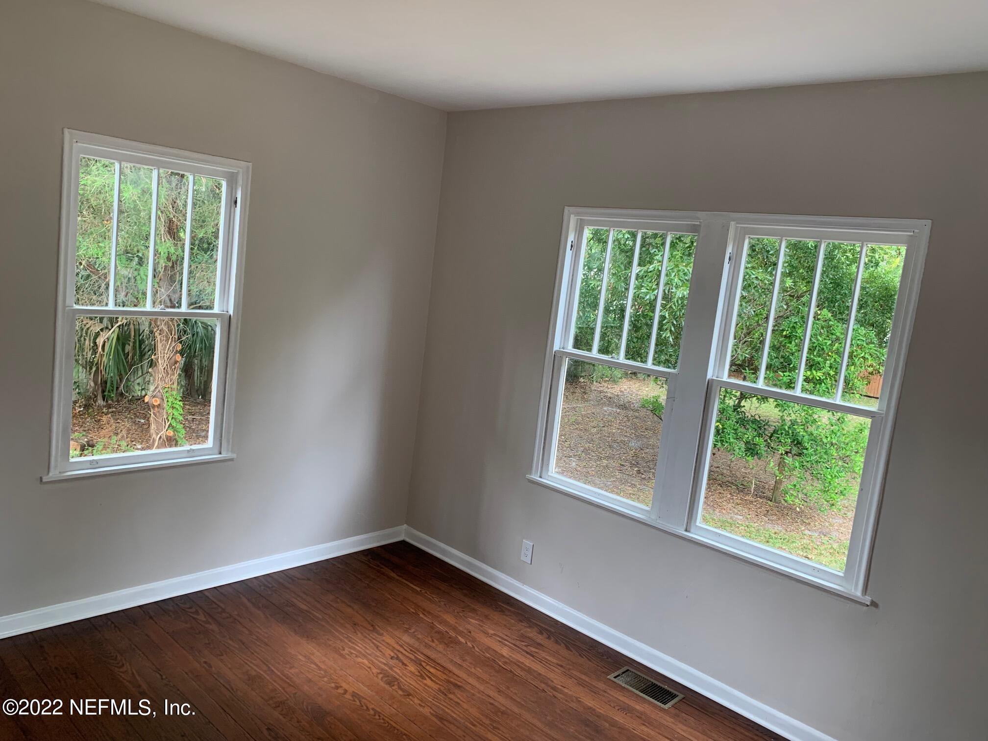 1821 Anniston Road Jacksonville, FL 32246 - Photo 8 of 11 a view of an empty room with wooden floor and a window