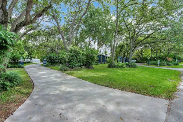 a view of a house with backyard sitting area and garden