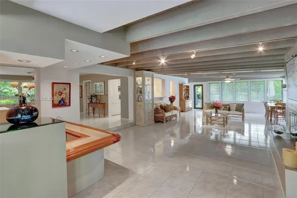 a living room with furniture a chandelier and a dining table