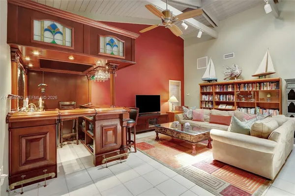 a living room with furniture rug and a large window