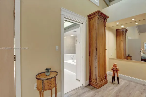 a bathroom with a sink a vanity and a large mirror