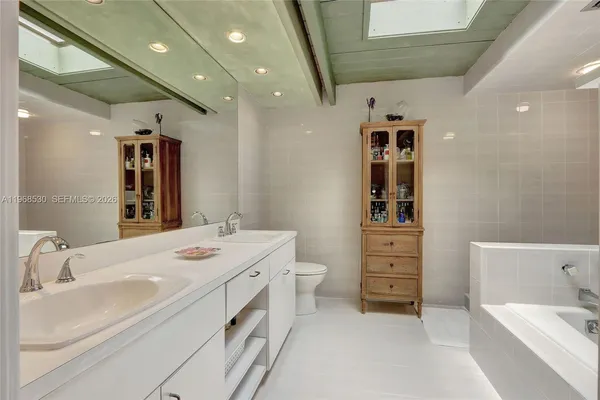 a bathroom with a double vanity sink mirror and