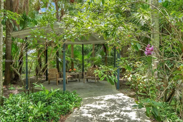 a view of a patio with a table chairs and a backyard