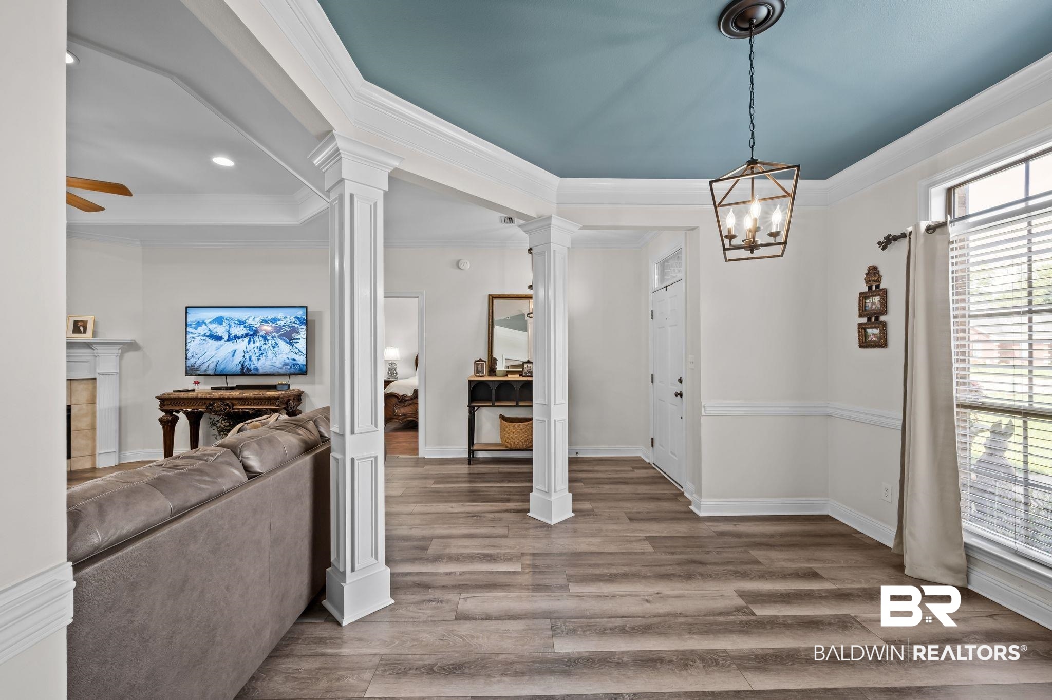 9837 Harmony Ridge Drive Semmes, AL 36575 - Photo 6 of 29 Entrance foyer with decorative columns, wood finished floors, baseboards, ceiling fan with notable chandelier, and ornamental molding