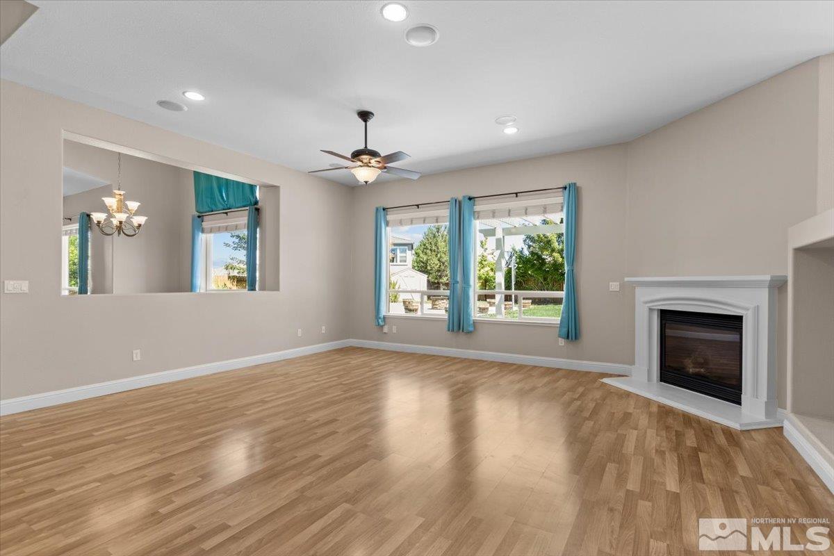 10560 Dillingham Drive Reno, NV 89521 - Photo 8 of 40 a view of an empty room with window and wooden floor