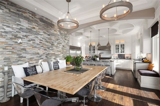 a view of a dining room with furniture a chandelier and wooden floor