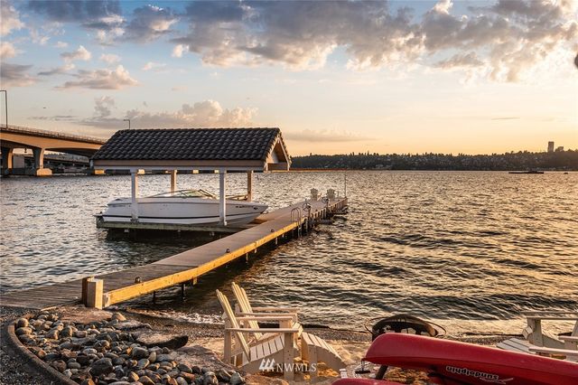 a roof deck with table and chairs under an umbrella