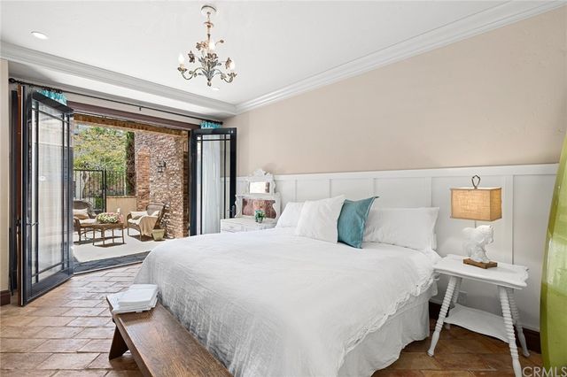 a bedroom with a large bed and a large window