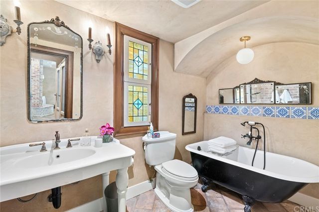 a bathroom with a sink vanity granite and toilet