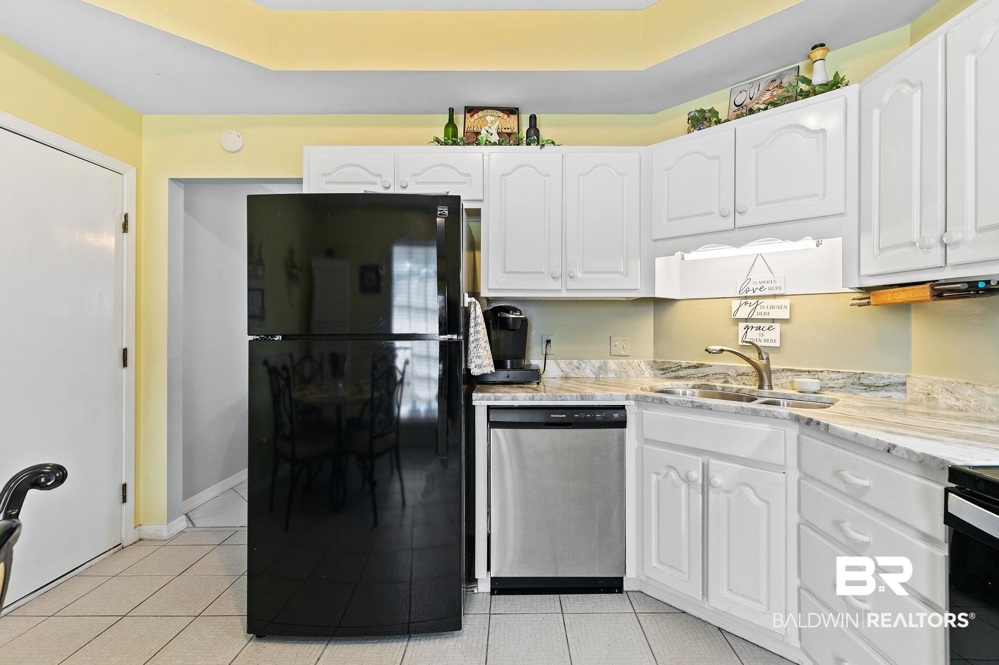 519 Juniper Place Drive Foley, AL 36535 - Photo 18 of 47 Kitchen featuring white cabinetry and freestanding refrigerator