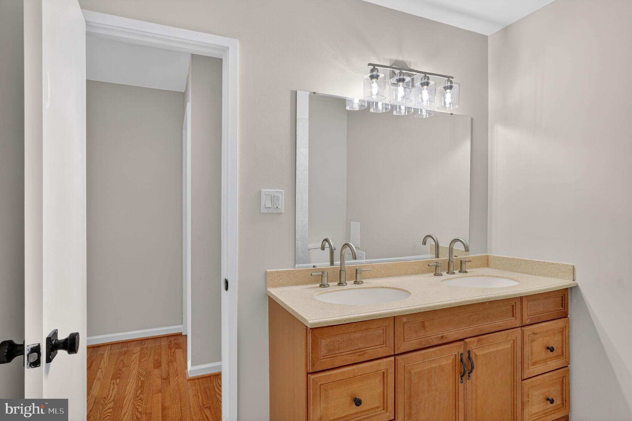 3052 Sugar Lane Vienna, VA 22181 - Photo 17 of 28 a bathroom with a sink vanity and mirror