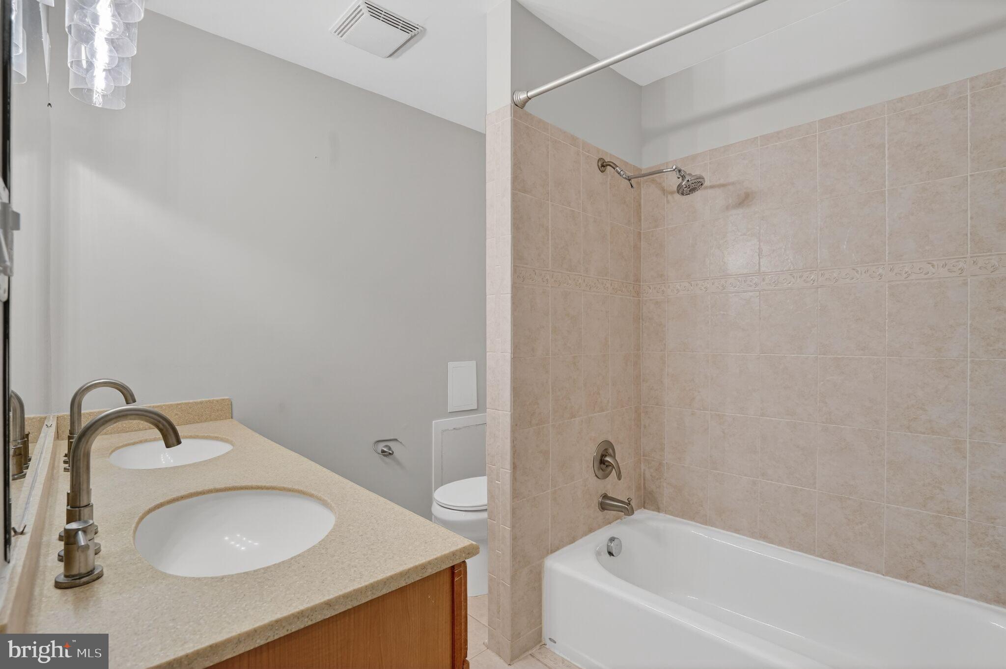 3052 Sugar Lane Vienna, VA 22181 - Photo 18 of 28 a bathroom with a granite countertop sink and a mirror