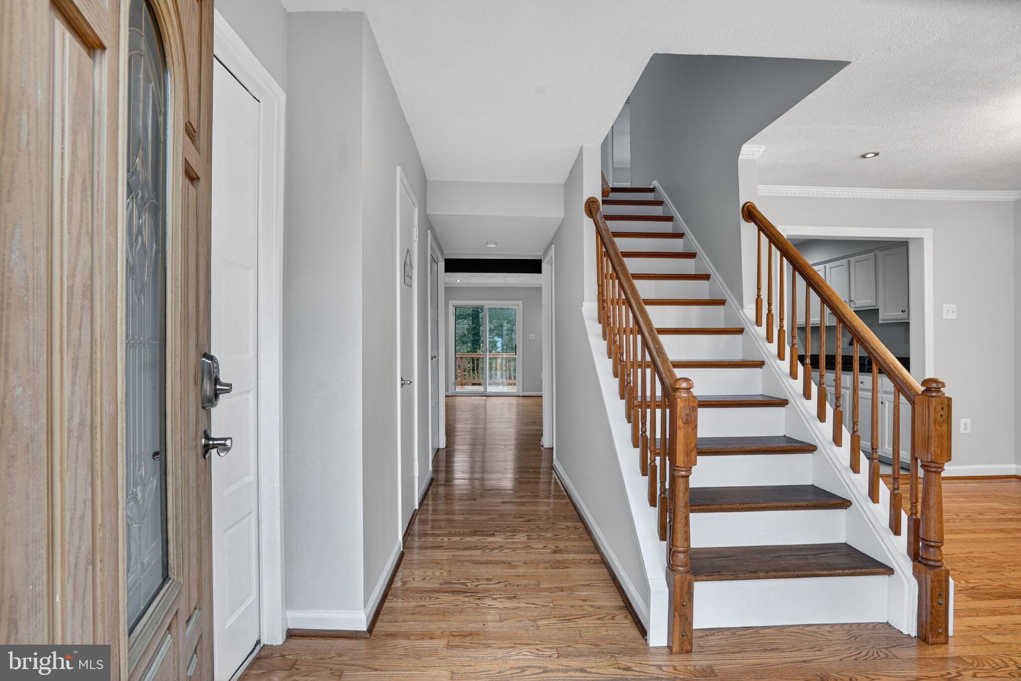 3052 Sugar Lane Vienna, VA 22181 - Photo 3 of 28 a view of staircase with wooden floor and white walls