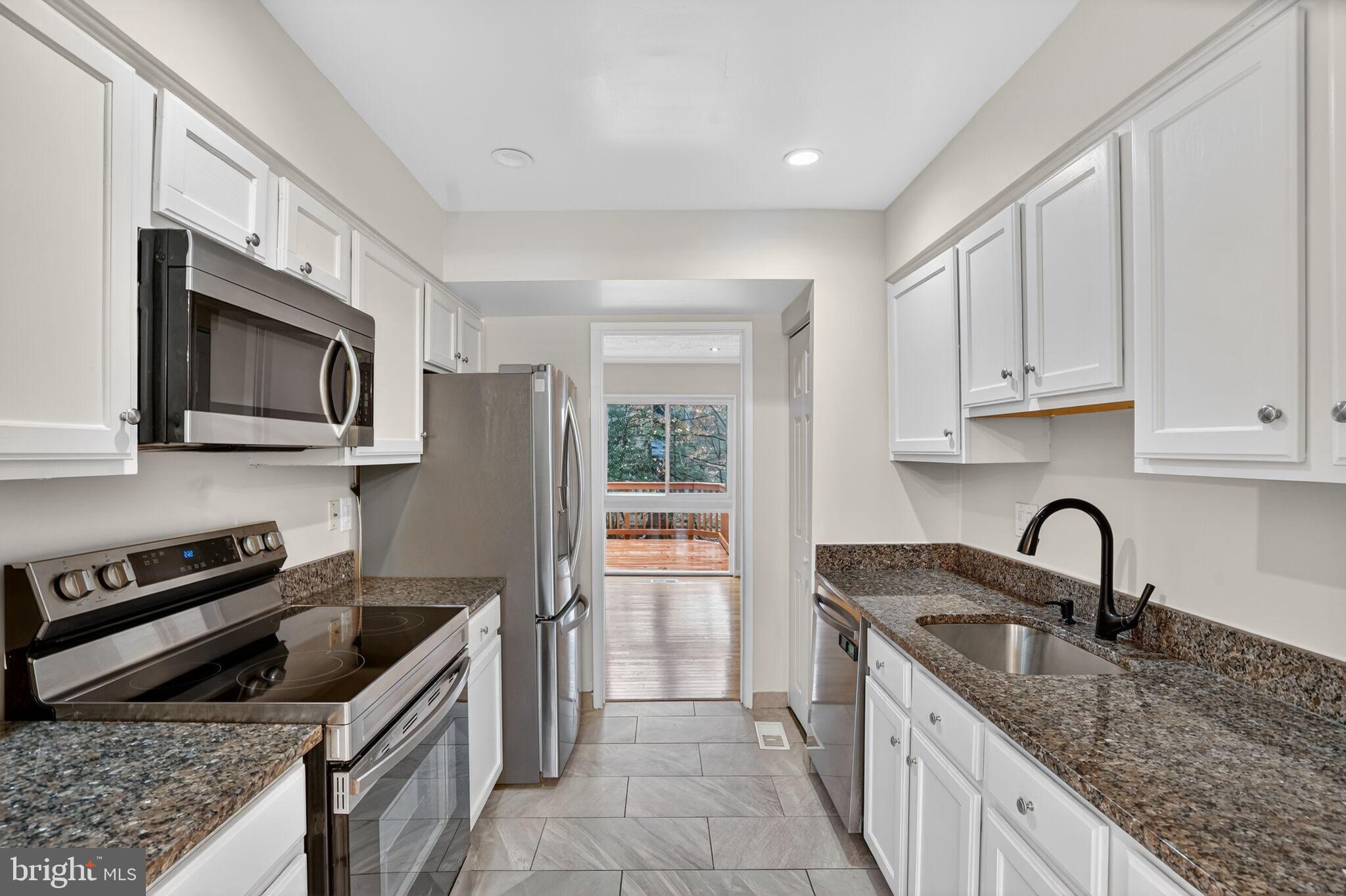 3052 Sugar Lane Vienna, VA 22181 - Photo 6 of 28 a kitchen that has a sink and a stove top oven