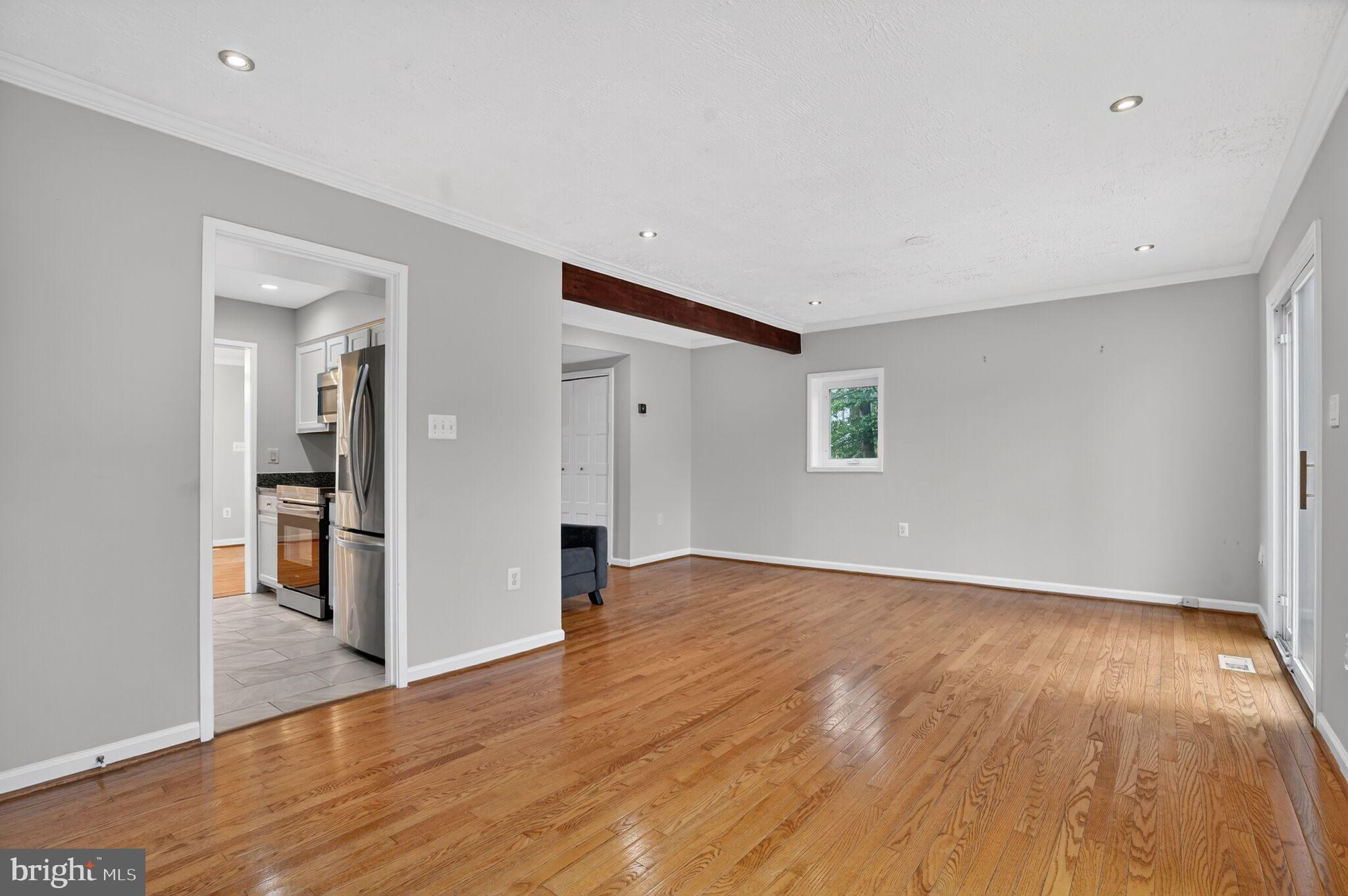 3052 Sugar Lane Vienna, VA 22181 - Photo 8 of 28 a view of an empty room with wooden floor and a window