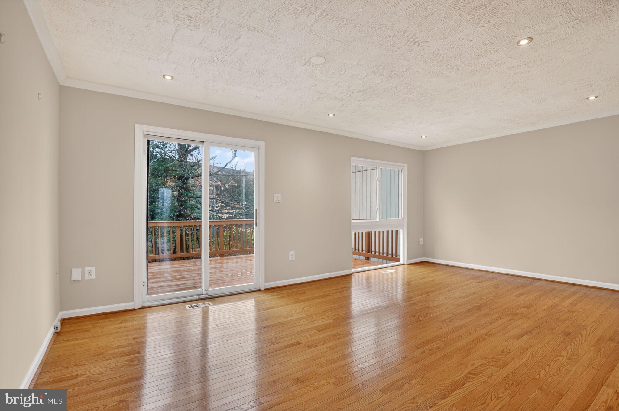 3052 Sugar Lane Vienna, VA 22181 - Photo 9 of 28 a view of an empty room with wooden floor and a window