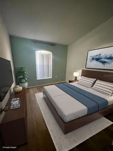 a bedroom with a bed and a window