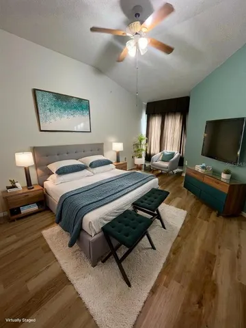 a bedroom with a bed and a flat screen tv