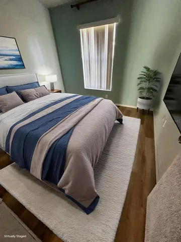 a bedroom with a bed and window
