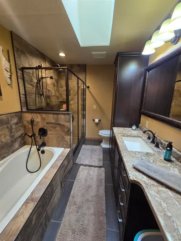 a living room with furniture and a dining table with wooden floor