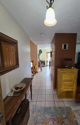 a kitchen with a sink refrigerator and cabinets