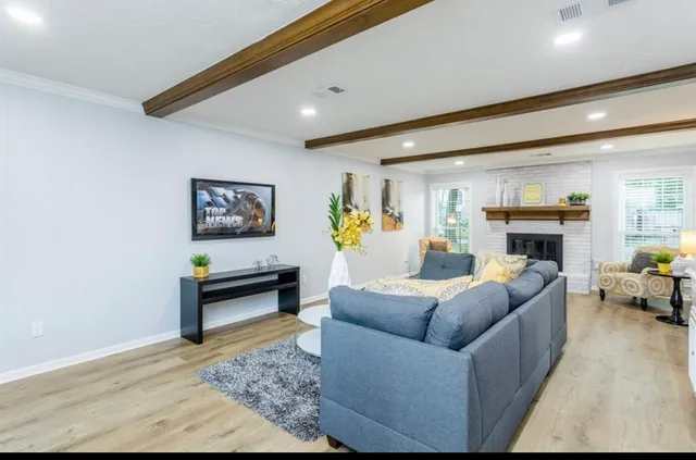 a living room with furniture and a fireplace
