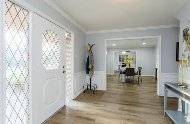 a room with lots of furniture and wooden floor