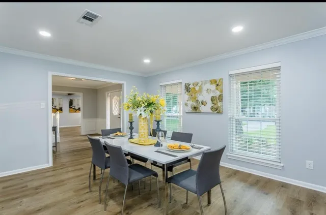 a view of a dining room with furniture window and wooden floor