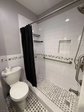a bathroom with a toilet and a shower