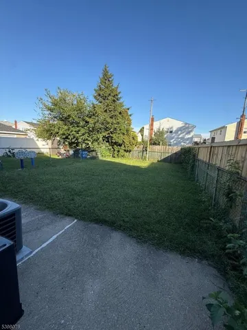 a view of a big yard with potted plants and mountain view
