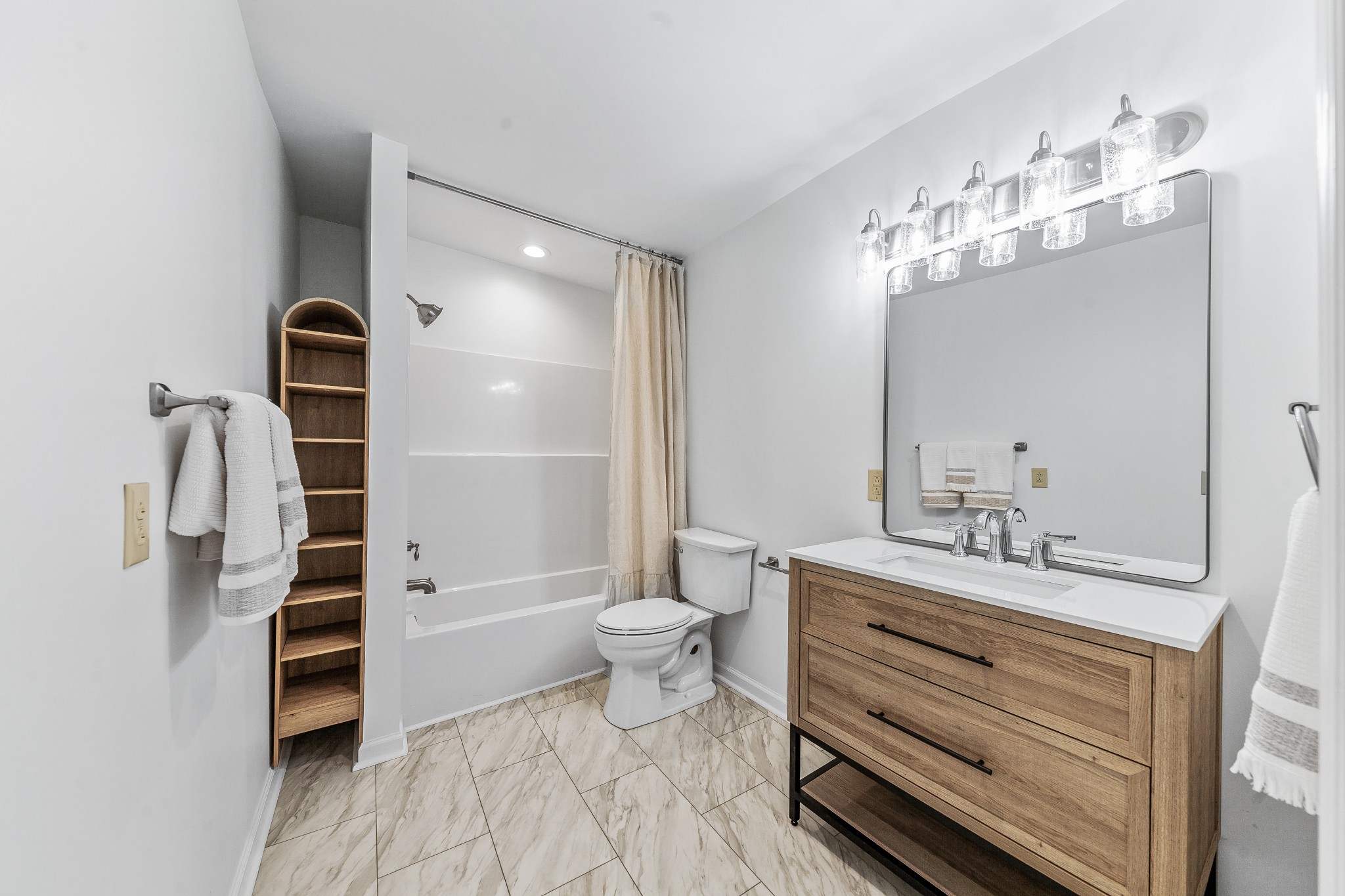 128 North Main Street Loretto, TN 38469 - Photo 19 of 32 a bathroom with a double vanity sink a toilet and a mirror