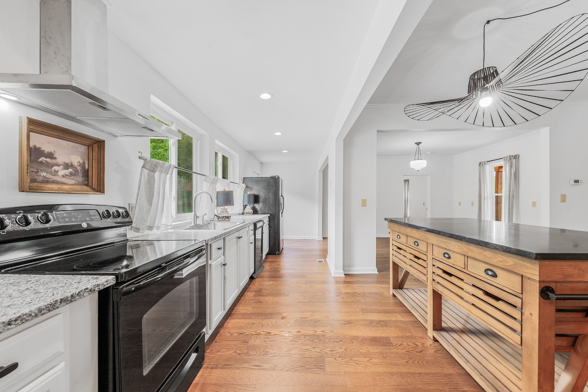 128 North Main Street Loretto, TN 38469 - Photo 7 of 32 a large kitchen with stainless steel appliances granite countertop a stove and a sink