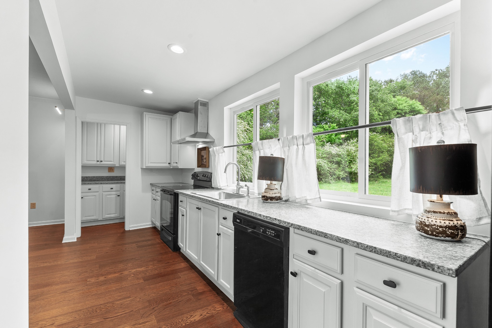 128 North Main Street Loretto, TN 38469 - Photo 8 of 32 a kitchen with a sink appliances cabinets and a large window
