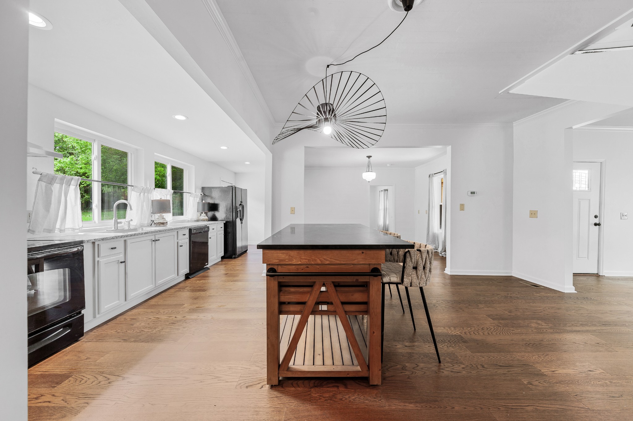 128 North Main Street Loretto, TN 38469 - Photo 9 of 32 a kitchen with stainless steel appliances granite countertop a stove a sink dishwasher and a refrigerator with wooden floor