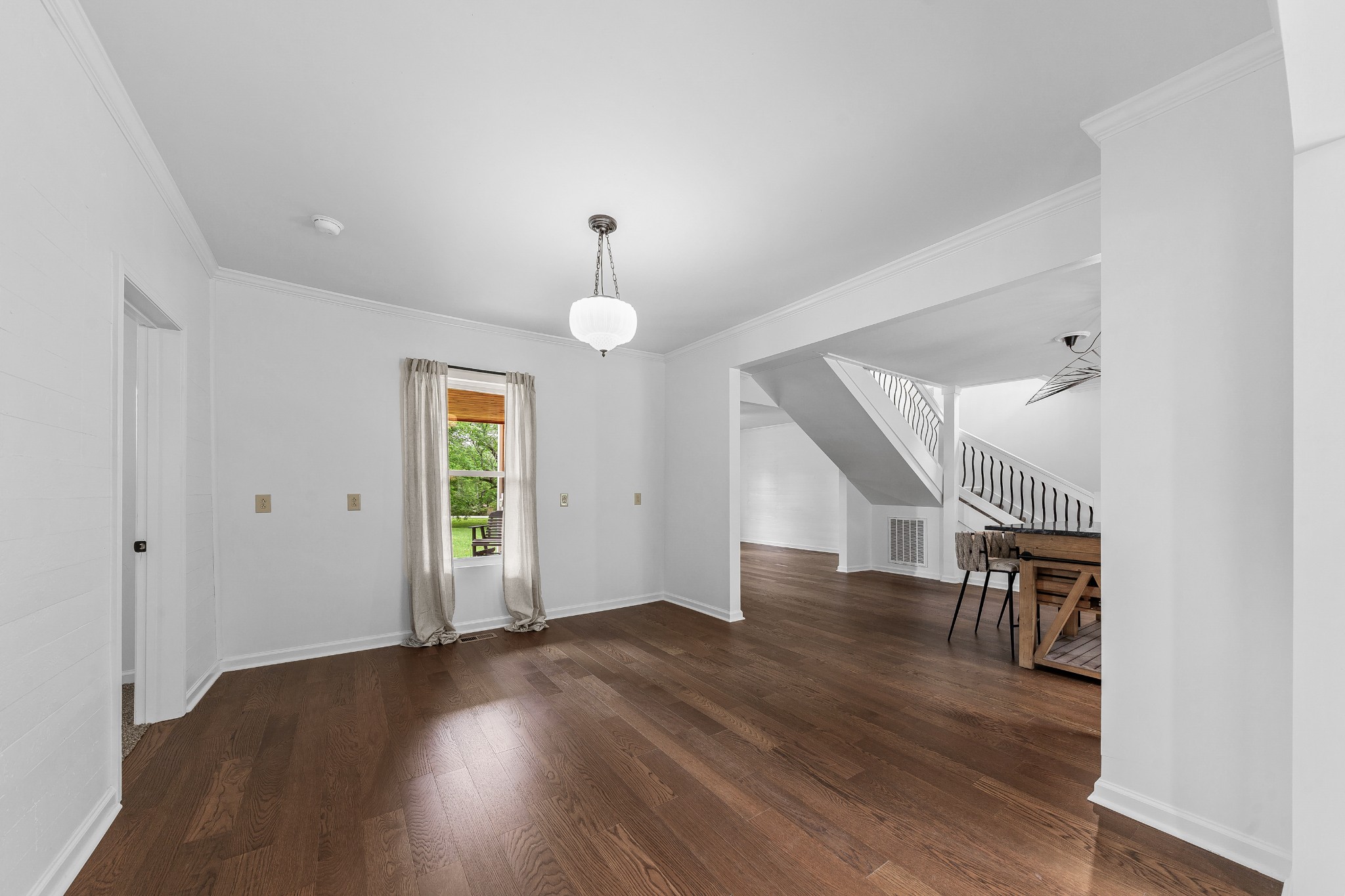 128 North Main Street Loretto, TN 38469 - Photo 10 of 32 an empty room with wooden floor and staircase