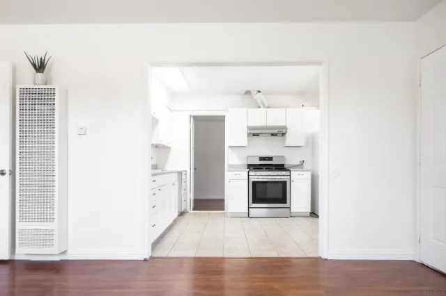 a kitchen with a refrigerator and a stove top oven