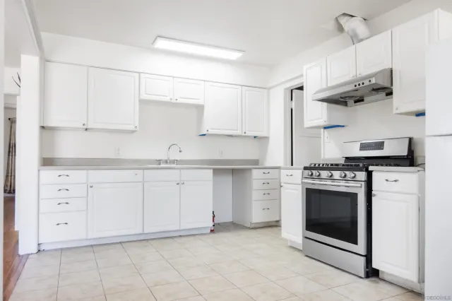 a kitchen with cabinets appliances and a sink