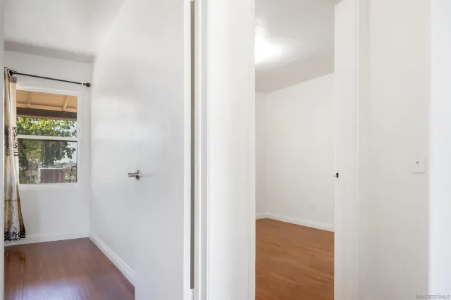 a view of a hallway with wooden floor