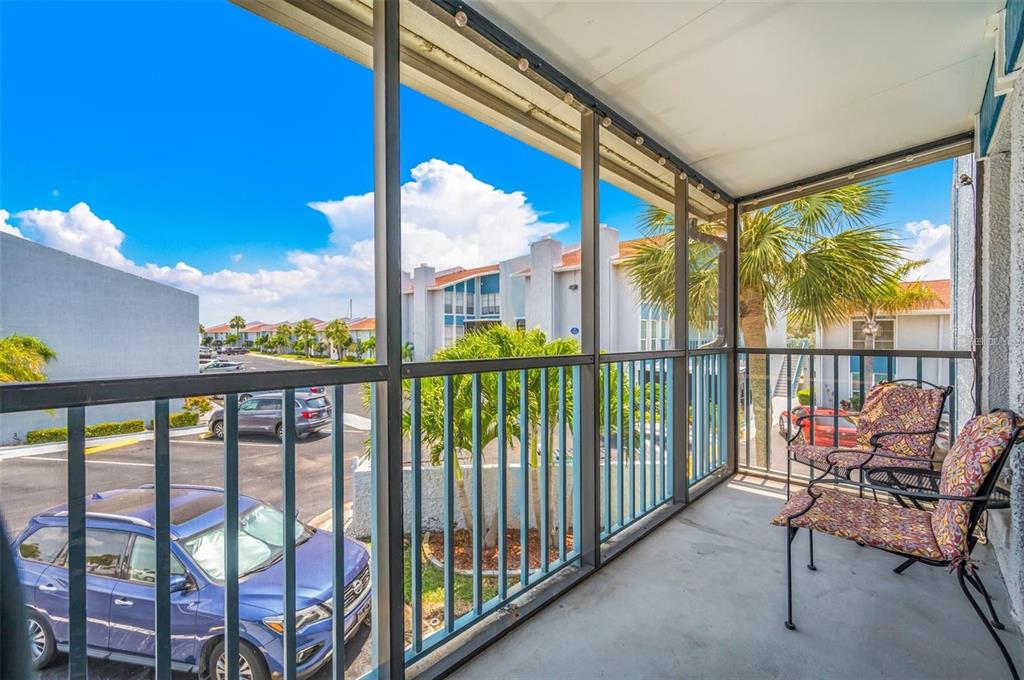 260 Medallion Boulevard, Unit F Madeira Beach, FL 33708 - Photo 18 of 29 a view of a chairs and table in the balcony