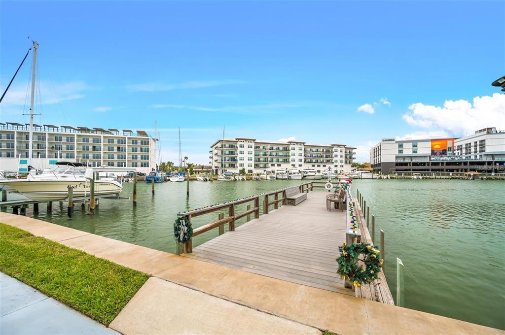 260 Medallion Boulevard, Unit F Madeira Beach, FL 33708 - Photo 27 of 29 a view of a lake with boats and trees in the background
